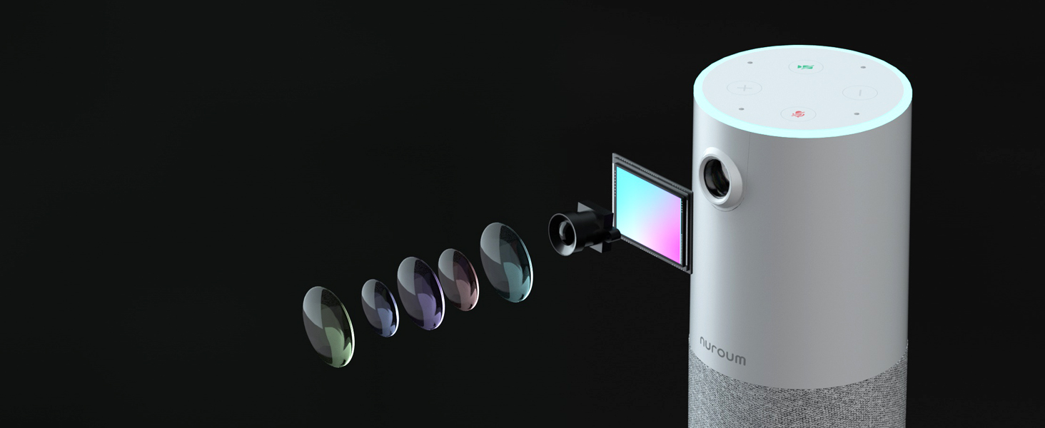 White cylindrical device projecting colorful light, with small dark objects floating in front, against a black background.