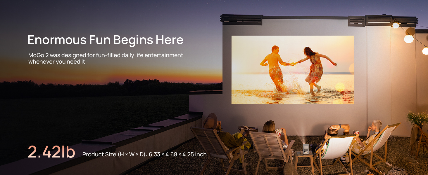 Outdoor projection screen setup. Image shows people on beach projected onto screen. Text reads 'Enormous Fun Begins Here' and '2.42lb'. Patio furniture visible in foreground.