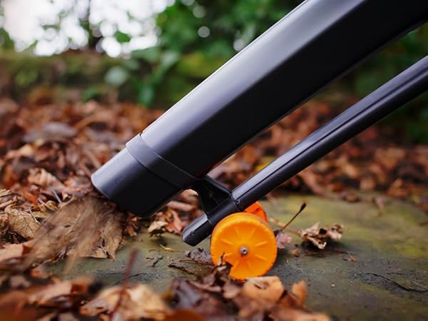 Close-up of pencil shavings and sharpener on brown surface with dramatic lighting.