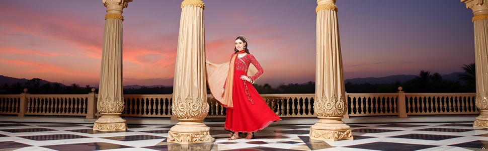 A vibrant and ornate display of traditional Indian fabrics and embroidery, showcasing the intricate