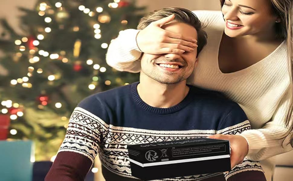 Couple in festive sweaters exchanging gifts by a Christmas tree. Warm lighting and holiday decorations visible in background.