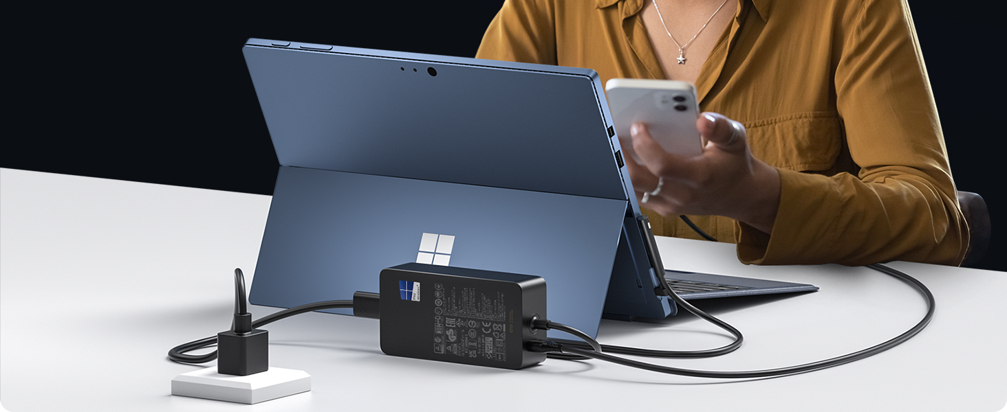 a person using a laptop and a phone