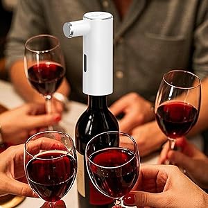Multiple wine glasses filled with red wine being examined and swirled in professional tasting setting against dark background.