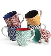 Collection of decorative coffee mugs featuring various geometric patterns in colors including red, blue, mint green, and black with contrasting interior colors.