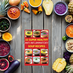 A rustic wooden table with a steaming bowl of soup surrounded by fresh vegetables and herbs.