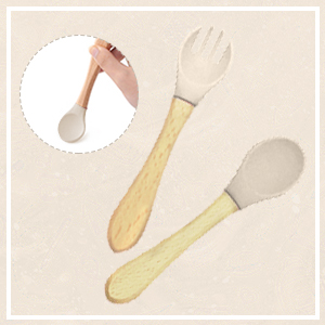 Three kitchen utensils with wooden handles and white tops: a large spoon, a fork, and a smaller spoon, arranged on a beige background.