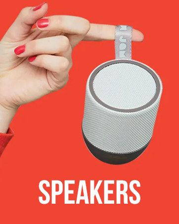 Compact portable speaker held by hand against red background. Cylindrical design with textured fabric exterior. Text 'SPEAKERS' visible at bottom.