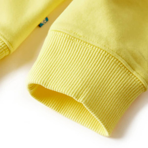 Close-up of yellow garment cuff showing ribbed elastic knit detail and stitching pattern.