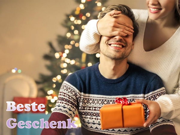 Der Text lautet „Bestes Geschenk“. Bild zum Thema Urlaub mit Weihnachtsbeleuchtung und Geschenkpräsentation.