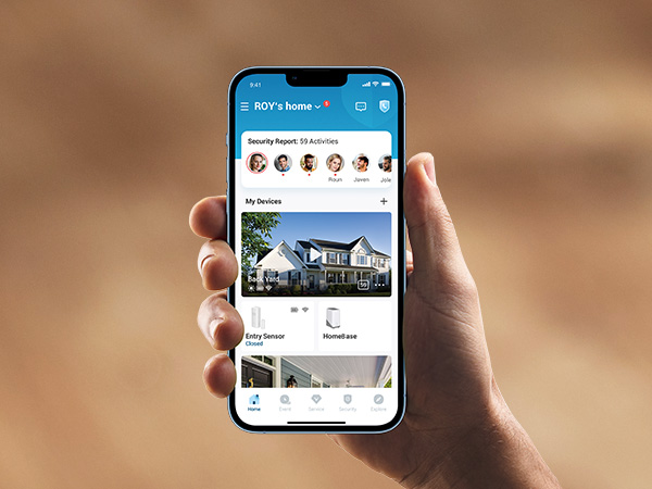 a hand holding a smartphone with a photo of a house on the screen