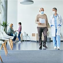 Masked doctor and patient walking together and talking