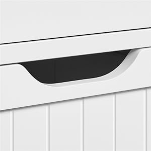 Close-up of a white furniture piece with a recessed handle or grip area in black.
