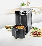 Digital air fryer shown with cooking results - french fries and other foods displayed on plates around it. Appliance features matte black finish with silver accents and pull-out cooking drawer.