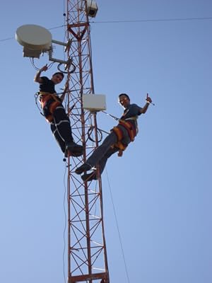 two men installing Cambium Networks products on a tower