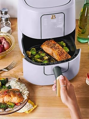 A collection of modern air fryers in black, lavender, white icing, and porcini colors.