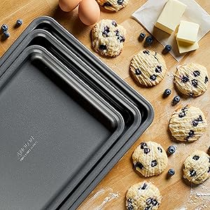 anolon baking sheets with blueberry cookies and butter and eggs around them