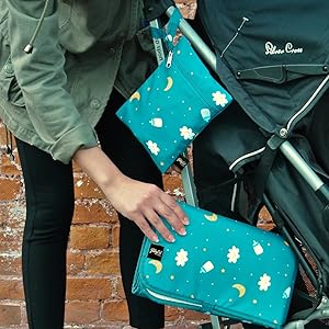 mother taking mat from stroller compartment