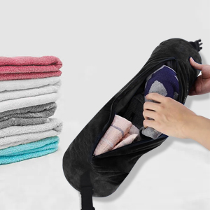 Une pochette de rangement en tissu noir est présentée avec des serviettes pliées de différentes couleurs affichées à côté.