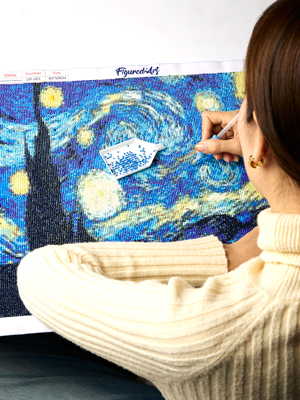 woman doing diamond painting