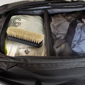 white horsehair leather boot brush on luggage ready to go on a quick trip