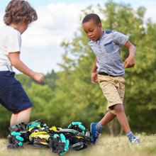 Two boys playing outside with race car