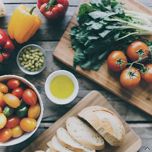 A vibrant and colorful array of fresh fruits and vegetables, artfully arranged on a rustic wooden ta