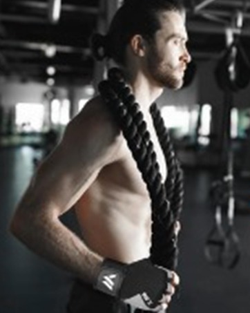 Black and white fitness gym scene showing exercise equipment and workout environment in dramatic lighting