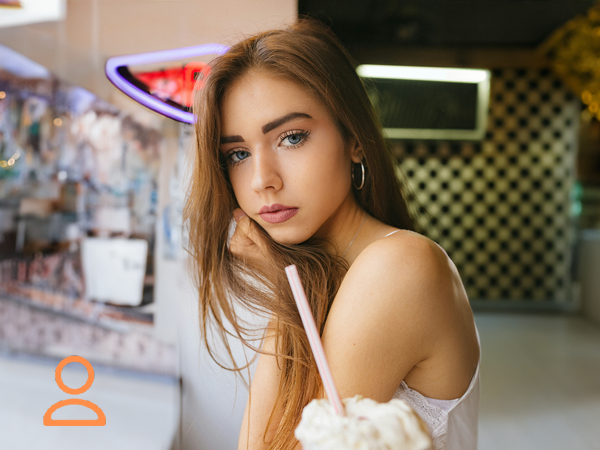 Girl in a Dinner with Neon Lights on the background in a Cafeteria from the 60 style