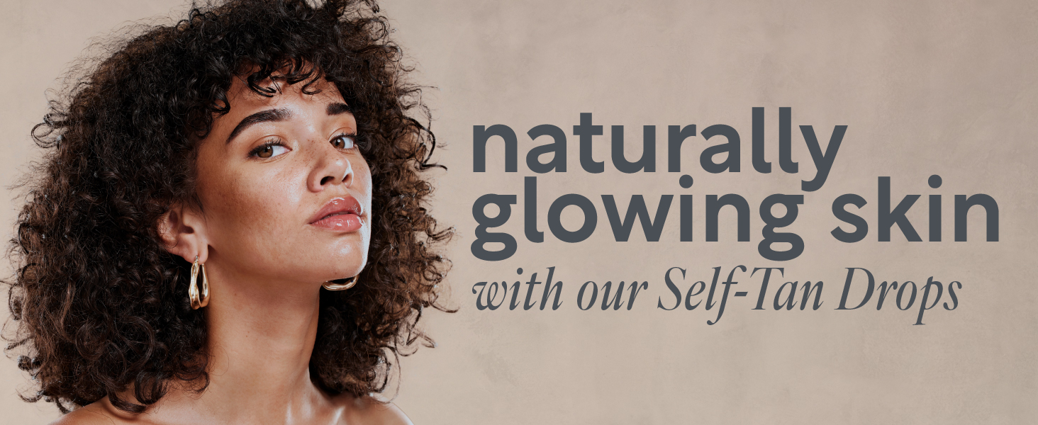  Woman looking into camera with a natural face tan from self tanning face drops. 