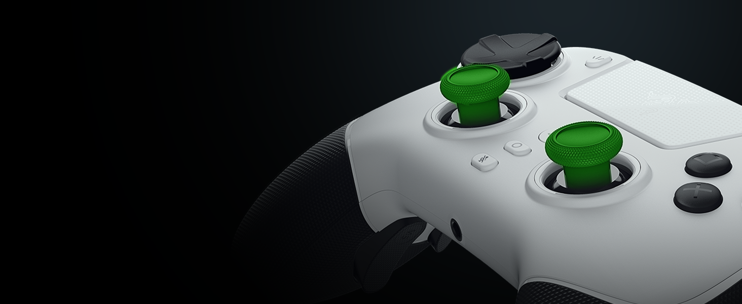 Close-up partial view of a white gaming controller with bright green analog sticks and black buttons against a dark background.