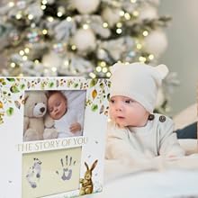baby looking into his baby memory book on his first christmas