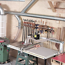 Ductwork goes along a wall of a shop inside a garage 