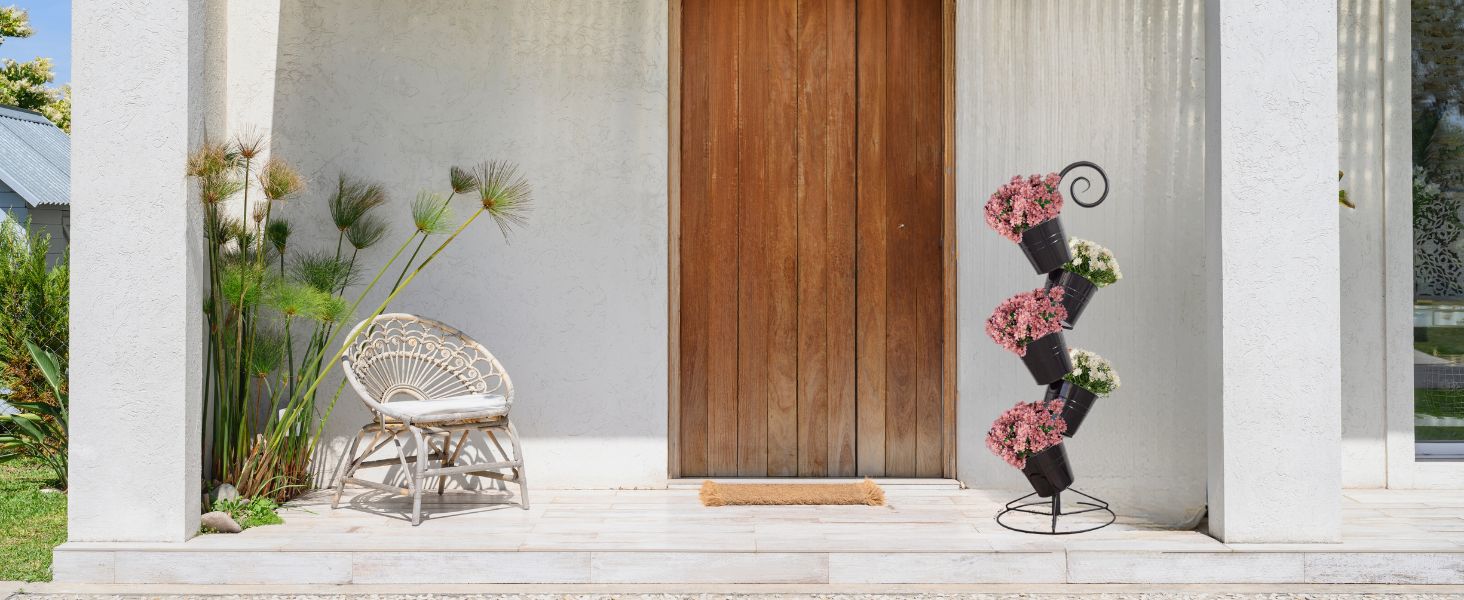 Image of Flower Pot Stand on front porch, with white and pink flowers planted. 