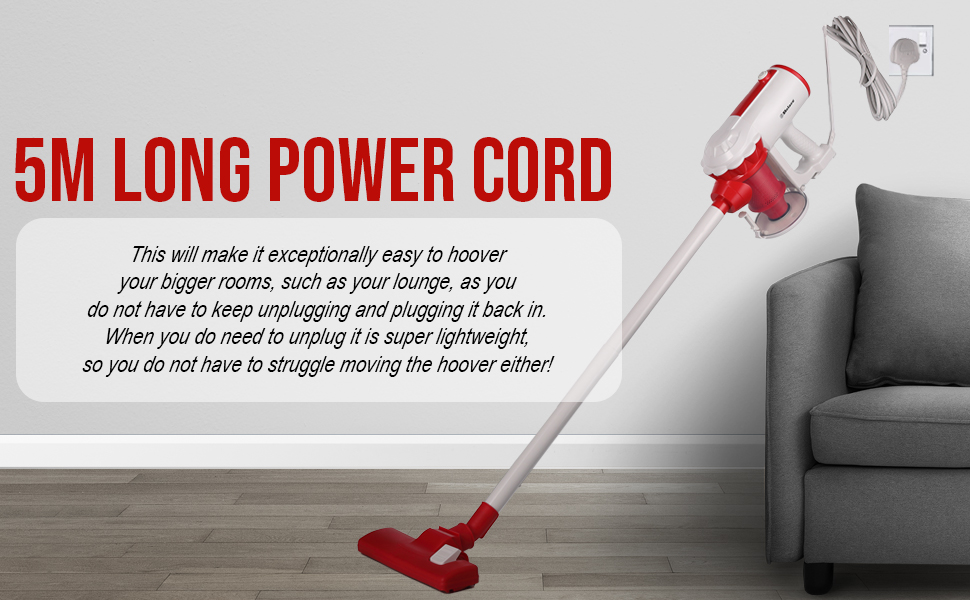 Red and white cordless stick vacuum cleaner with 5M long power cord, shown in use on carpet near a gray sofa.