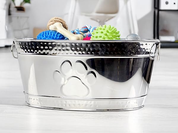 Dog toy basket made of durable stainless steel for aggressive chewers that includes a paw print.
