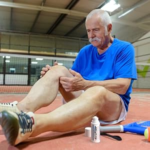 Senior applying Acuplus to his knee before playing Tennis.