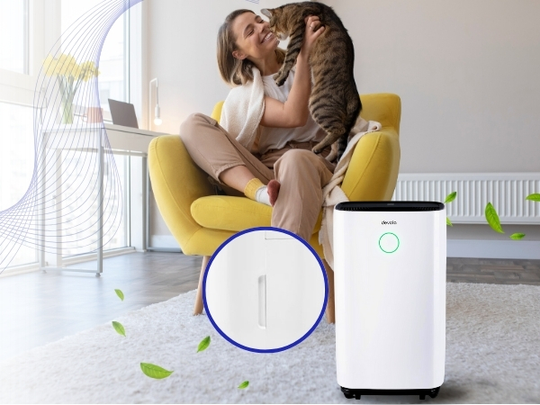 Two white air purifier units with blue accent rings displayed in living room setting with yellow accent chair.