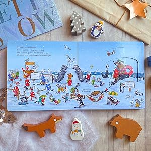 Lifestyle image of inside spread of the book with christmas props surrounding it