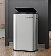 Stainless steel trash can with black lid, rectangular shape, positioned on wooden floor near dark cabinet in kitchen setting.