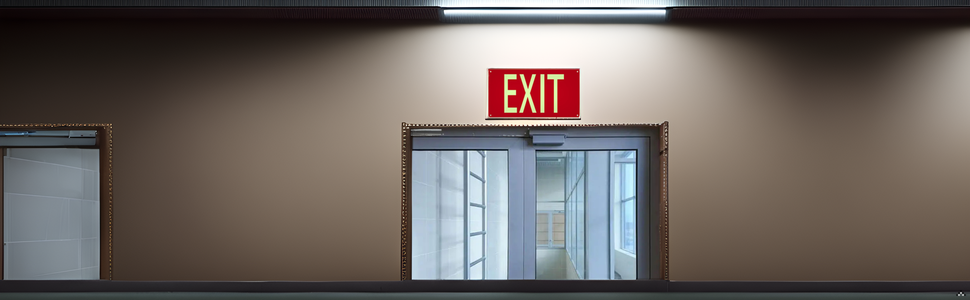 A dimly lit hallway with the product mounted on the wall, illuminating the path ahead.