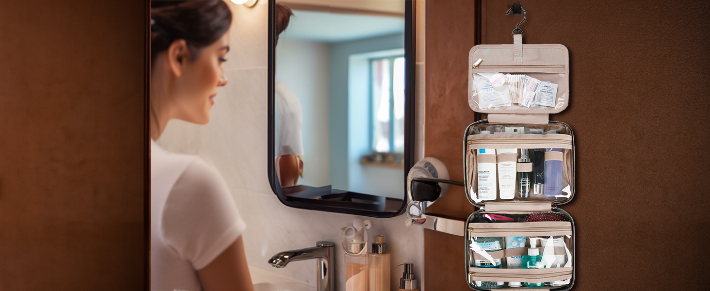Expandable hanging toiletry organizer with multiple compartments shown mounted on bathroom wall next to mirror, displaying organized personal care items.