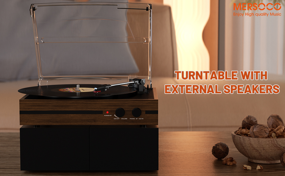 Wooden turntable with external speakers. Device has a clear plastic cover and is playing a vinyl record. Text overlay indicates functionality.