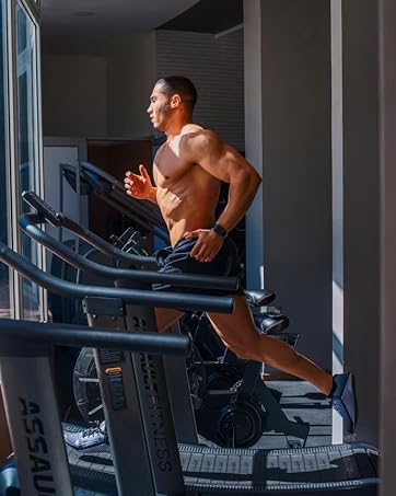 man running on a treadmill in a gym