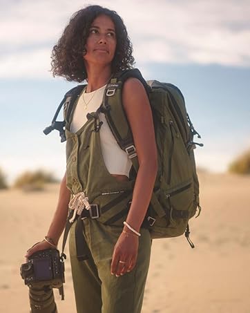 Photographer wearing pack and carrying camera