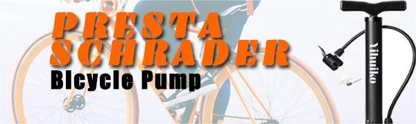 Black bicycle pump with T-handle and orange text 'PRESTA SCHRADER Bicycle Pump'. Partial bicycle wheel visible in background.