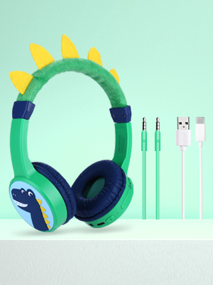 Kids' headphones in blue and green with dinosaur-like spikes, shown with matching audio cables against mint green background.