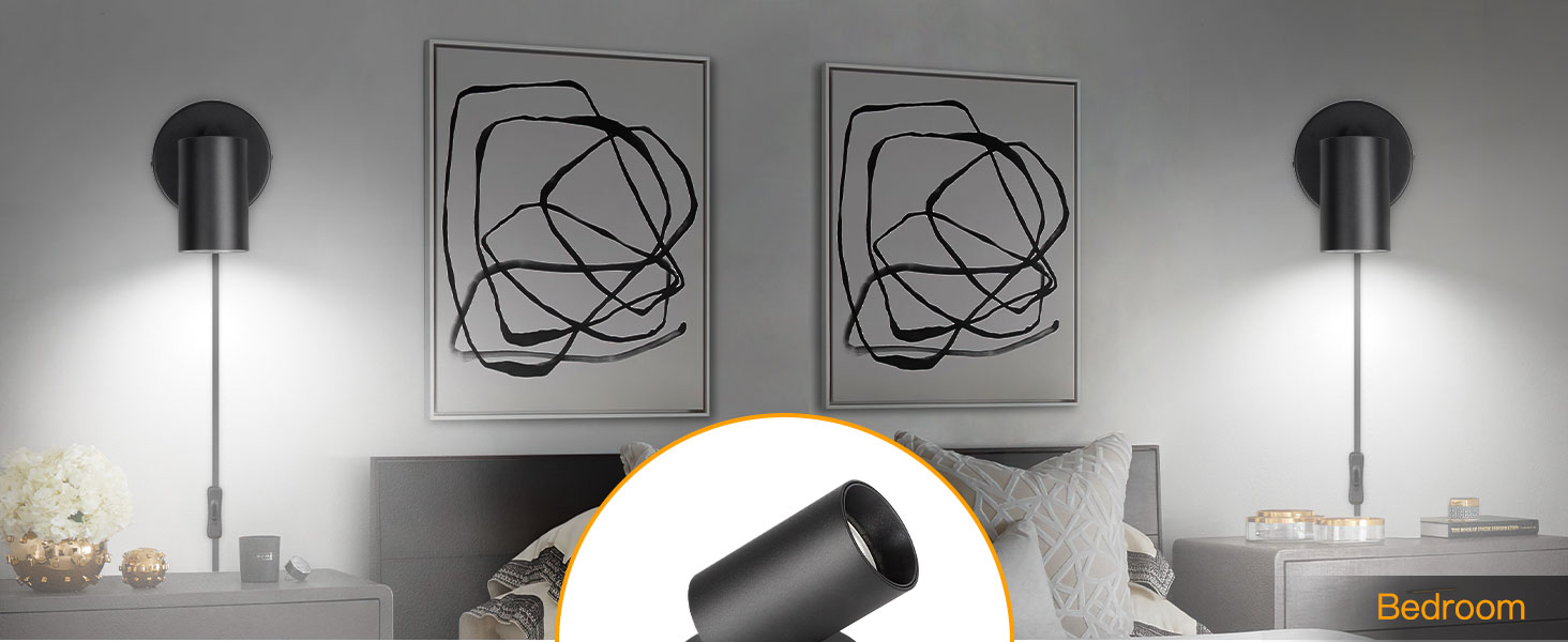 Black adjustable wall sconce light fixture with long arm, shown in use next to abstract wall art.
