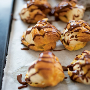 A photograph of Dorie Greenspan’s Ice Cream Filled Choux Pastries with Chocolate Sauce. 