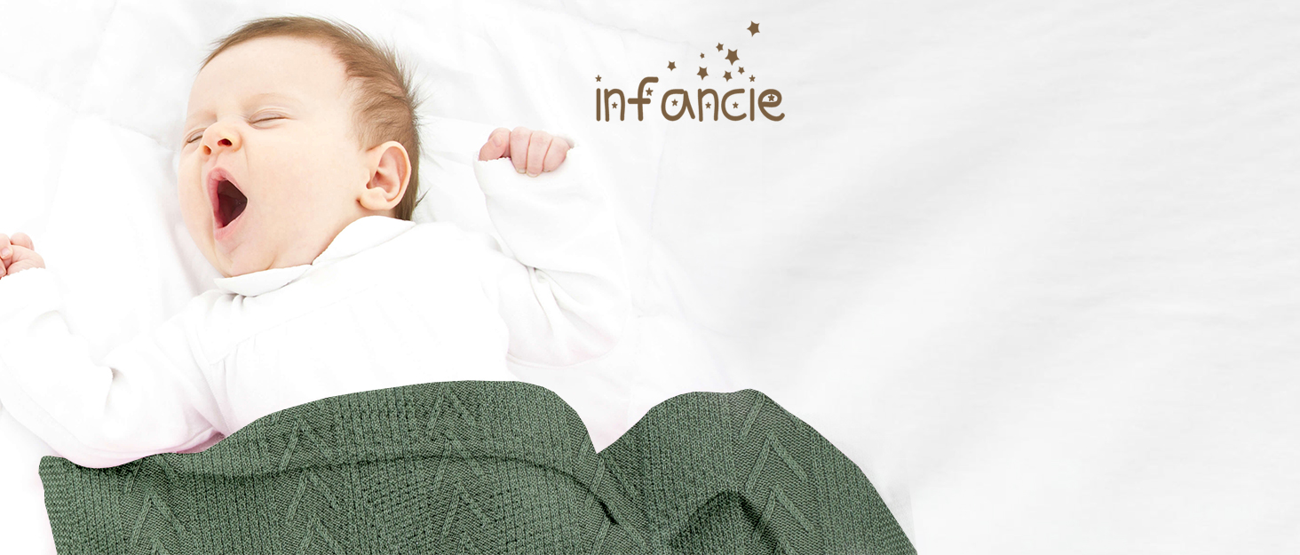 Yawning baby wrapped in dark green blanket. 'Infancie' text visible in image.