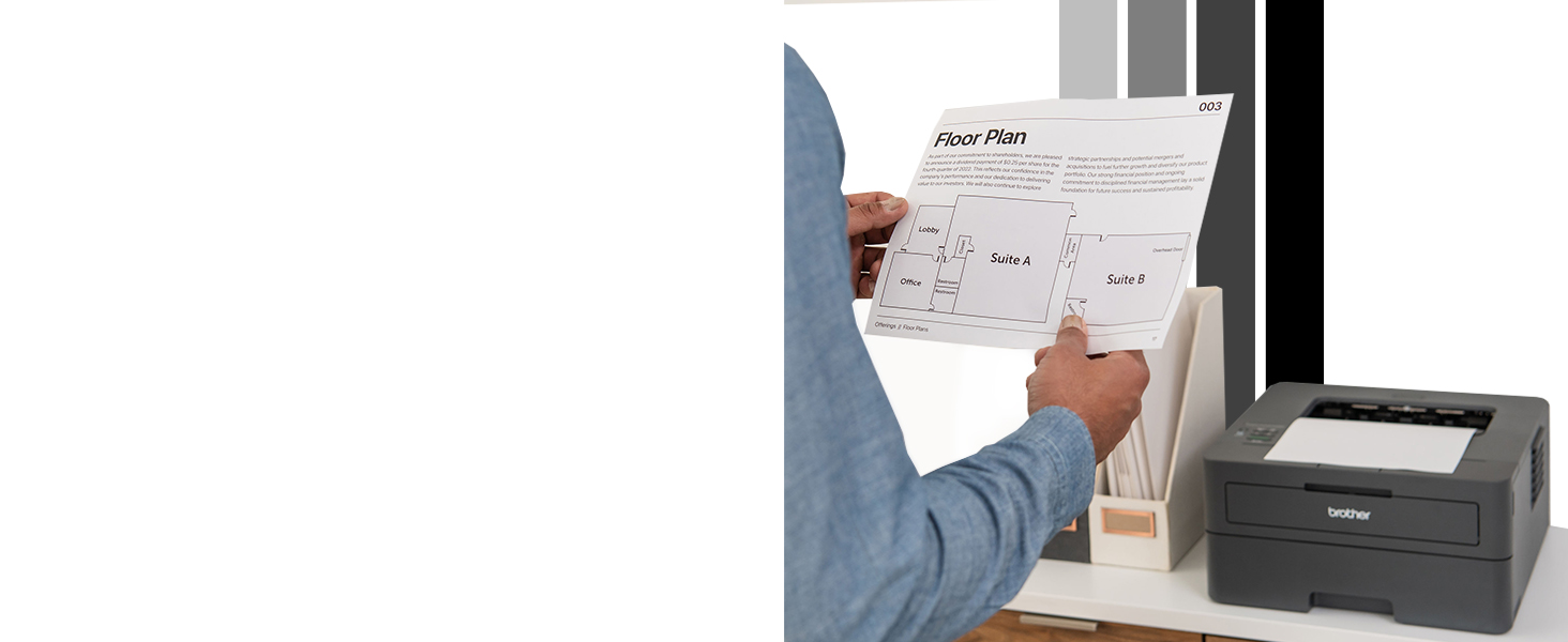 Person in home office reviewing b/w floor plan printed from Brother HL-L2405W mono laser printer